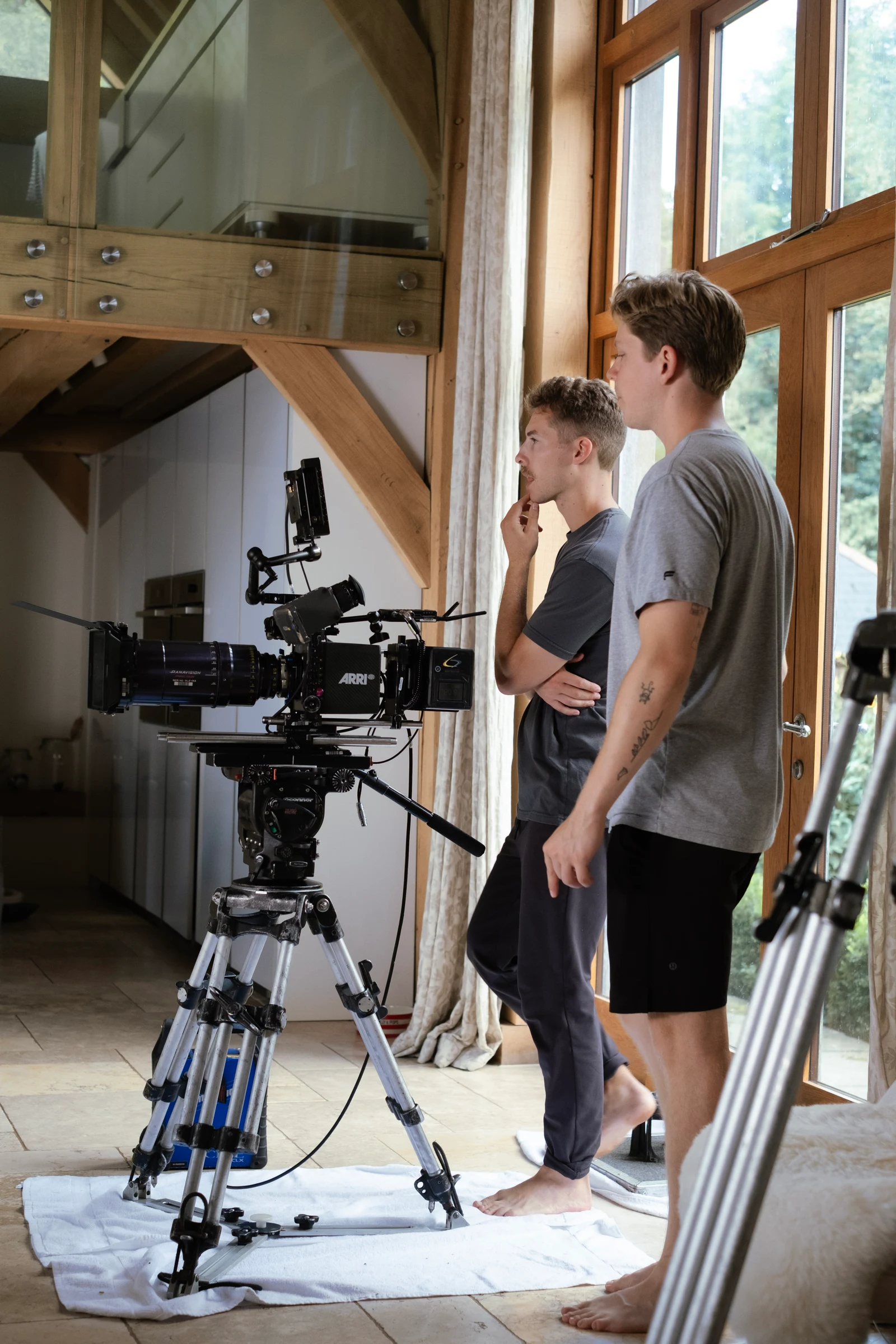 Scott Tinkham & Michael Woloson reviewing a camera setup inside the cottage