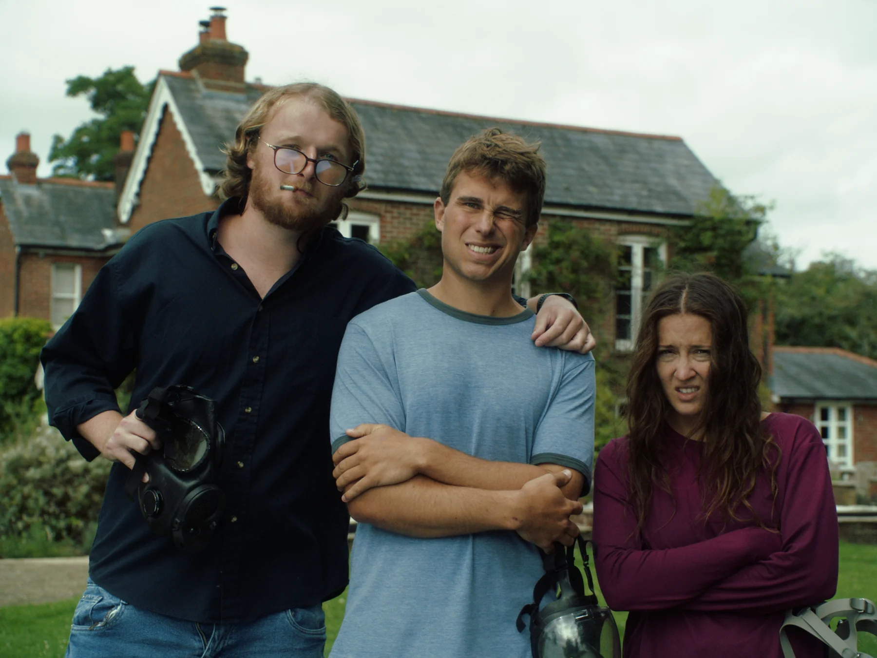 Chester, Liam, and Mel standing outside the cottage